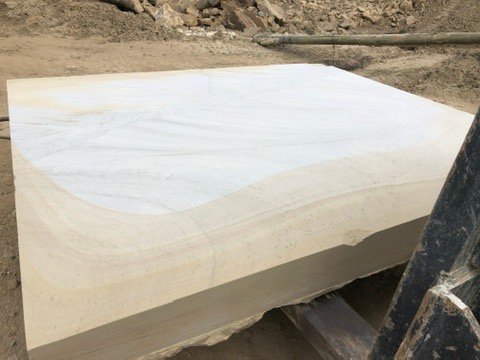 A freshly sawn sandstone block showing its natural banding